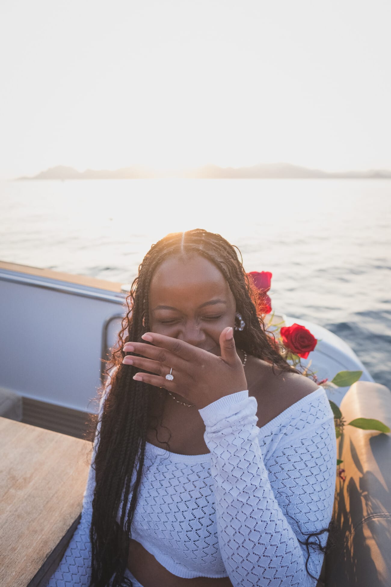 A Romantic Proposal on a Yacht between the Lérins Islands 19 Woman on yacht with roses at sunset