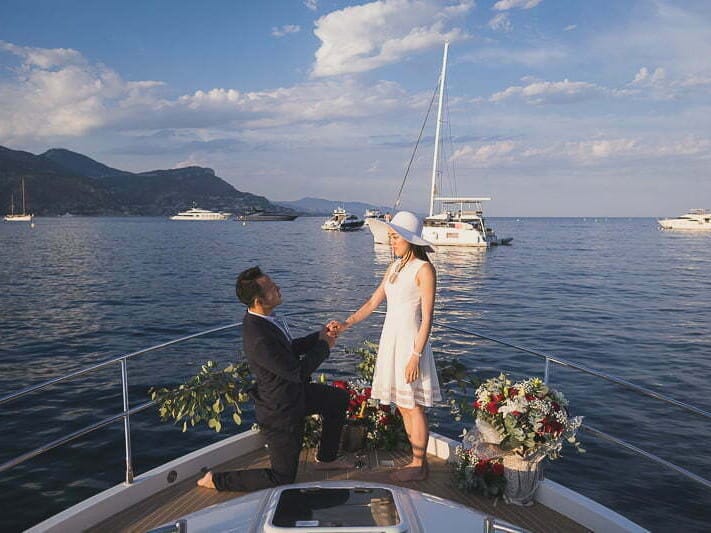 Emotional French Riviera proposal on a yacht with Monaco in the far backdrop
